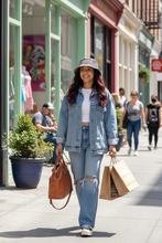 Load image into Gallery viewer, Young woman wearing Lucy Bucket Hat shopping in urban street
